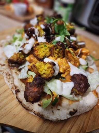 Naan bread smothered with mango chutney, lettuce and cucumber, covered in chicken tikka with onion bhajis and drizzled with riata. Chicken Tikka Flatbread